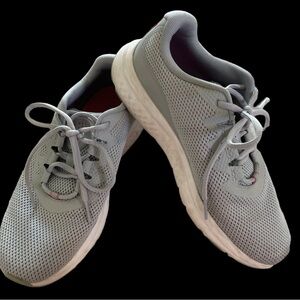 Light gray Under Armour athletic shoes. Cute pink detailing, sz 8.5, great cond.